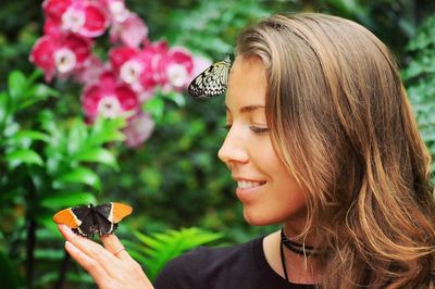 Close-up of young woman holding flower