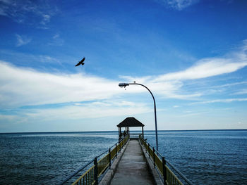 View of jetty leading to sea