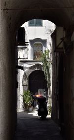 Rear view of man standing by building