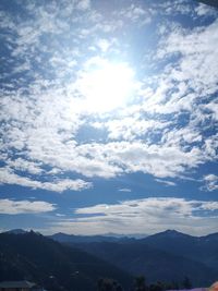 Scenic view of mountains against sky on sunny day