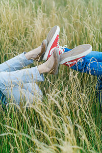 Low section of girl lying on field