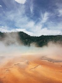 Scenic view of clouds over landscape against sky