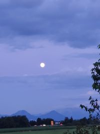 Scenic view of moon against sky at sunset