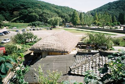 Scenic view of farm against trees