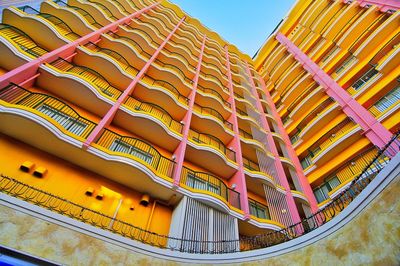 Low angle view of multi colored building against sky