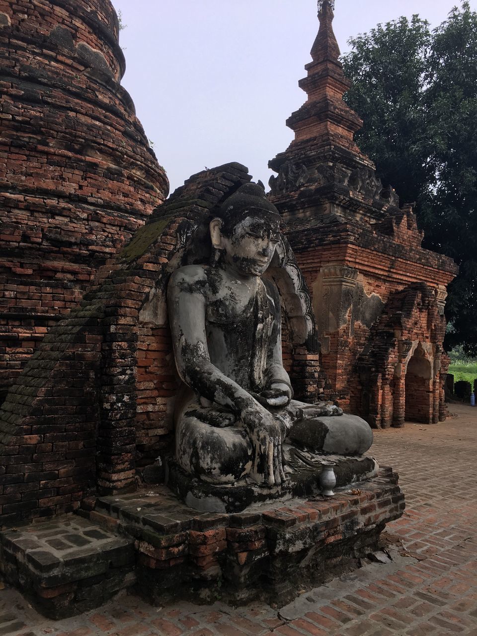 religion, place of worship, statue, human representation, spirituality, travel destinations, building exterior, no people, cultures, architecture, outdoors, day, sculpture, sky