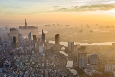 High angle view of city buildings during sunset