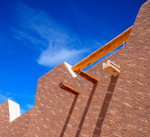 Low angle view of building against blue sky