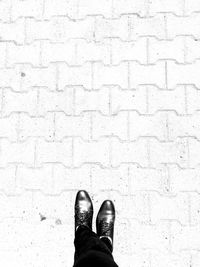 Low section of man standing on footpath