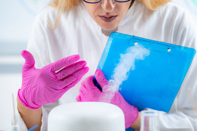 Olfactory lab scientist taking notes during aroma essential oil test