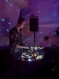 Woman looking at camera while standing at nightclub