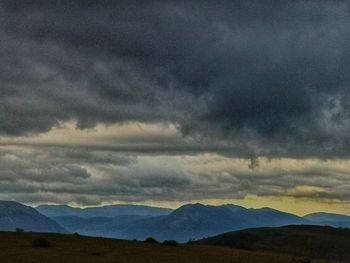 Scenic view of mountain against dramatic sky