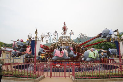 Statue in amusement park against sky