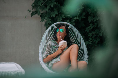 Young woman sitting outdoors