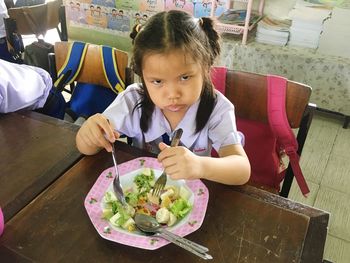 Portrait of girl eating food