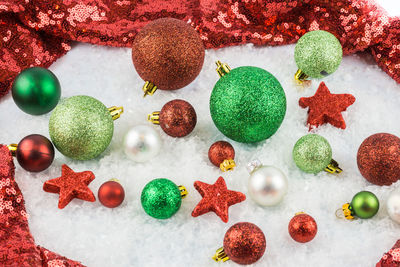 Close-up of multi colored baubles on snow