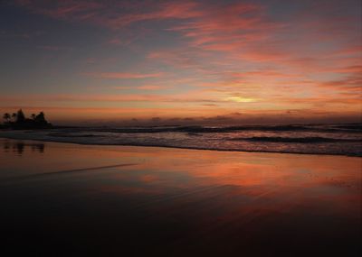 Scenic view of beach against sky during sunset