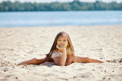 Young woman sitting at beach