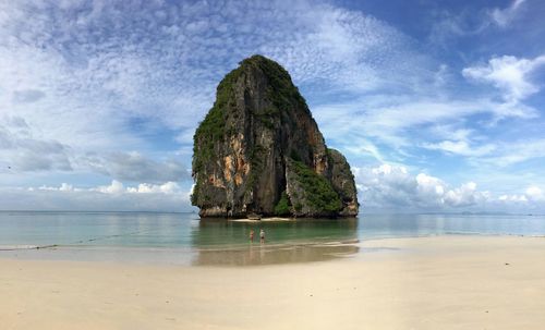 Scenic view of rock formation in sea against sky