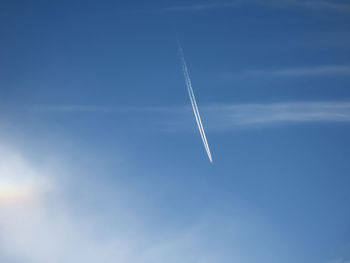 Low angle view of vapor trail