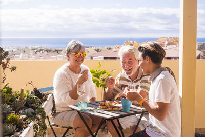 Happy family enjoying food at outdoors restaurant