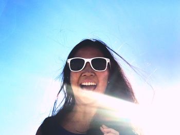 Portrait of woman wearing sunglasses against sky