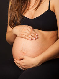 Midsection of woman touching hair