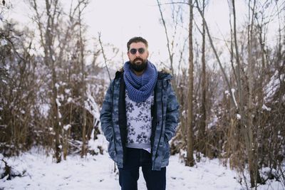Portrait of man standing in snow