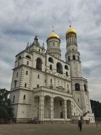 Low angle view of historical building against cloudy sky