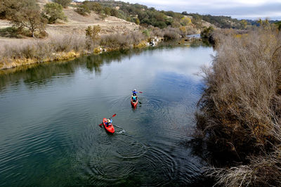 High angle view of people canoeing in lake