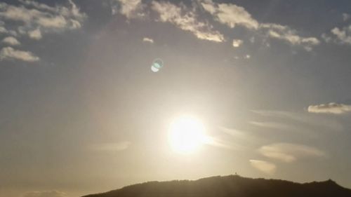 Scenic view of moon against sky at sunset