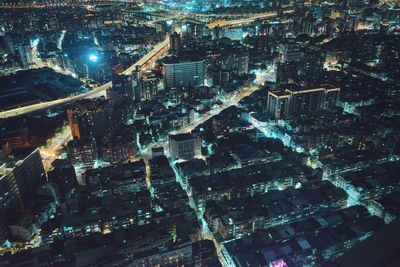 High angle view of illuminated modern buildings in city at night