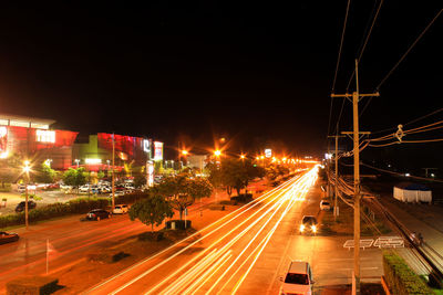 Light trails on road in city at night