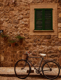 Bicycle parked against wall