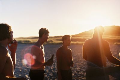 Group of people enjoying in water against sky