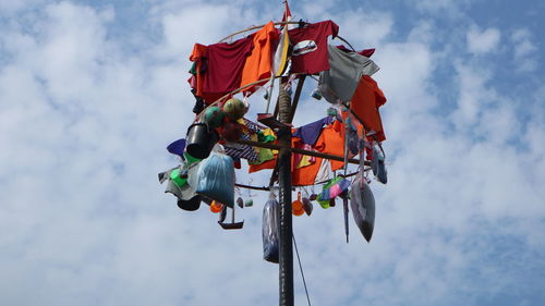 Low angle view of flags hanging against sky