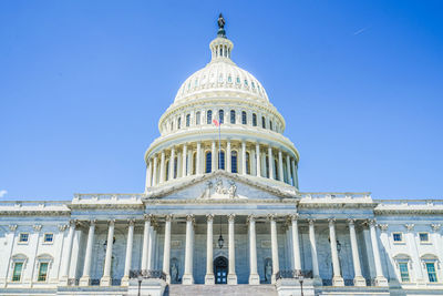 Low angle view of historic building against clear blue sky