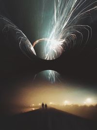 Low angle view of firework display at night