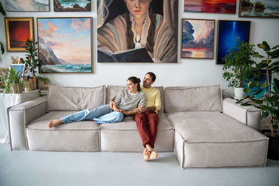 Portrait of woman sitting on sofa at home