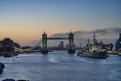 View of bridge over river against sky in city