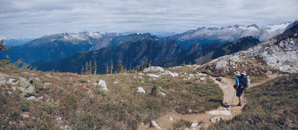 Rear view of person hiking on mountain