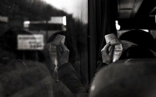 Low section of man standing in bus