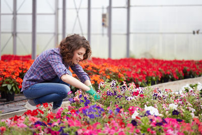 Smiling woman working in botanical garden