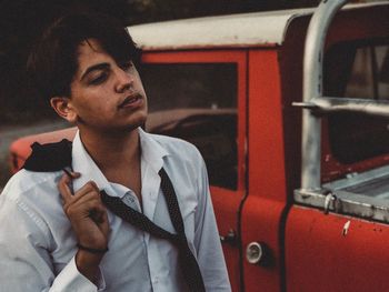 Young man wearing shirt and tie while looking away outdoors