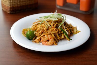 Mie goreng served in plate on wooden table