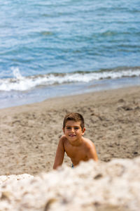 Little kid climbing a dune on a beach