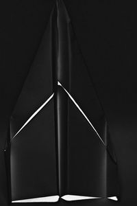 Close-up of illuminated lamp against wall at home