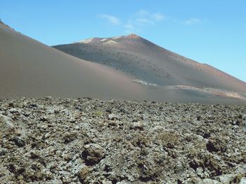 Scenic view of arid landscape against sky