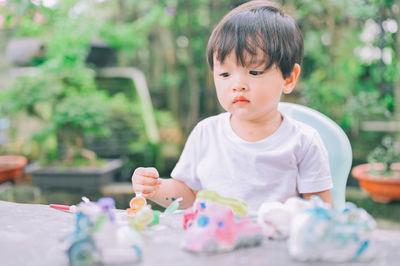 Cute boy looking at table