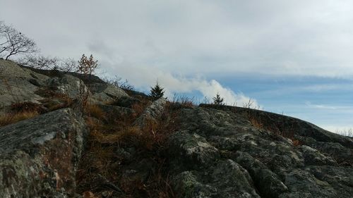 Low angle view of mountain against cloudy sky